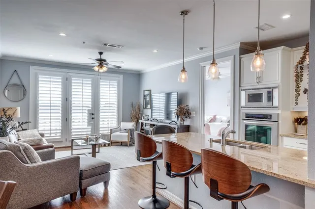 a living room with fireplace furniture and a large window