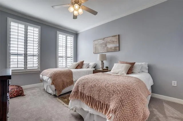 a bedroom with two beds and a chandelier