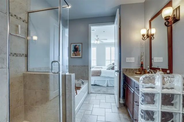 a bathroom with a tub sink and mirror