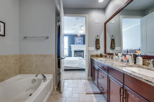 a spacious bathroom with a tub sink and mirror