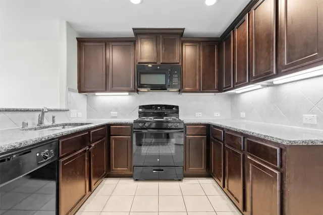 a kitchen with granite countertop stainless steel appliances and cabinets