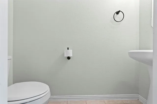 a bathroom with a toilet and a mirror