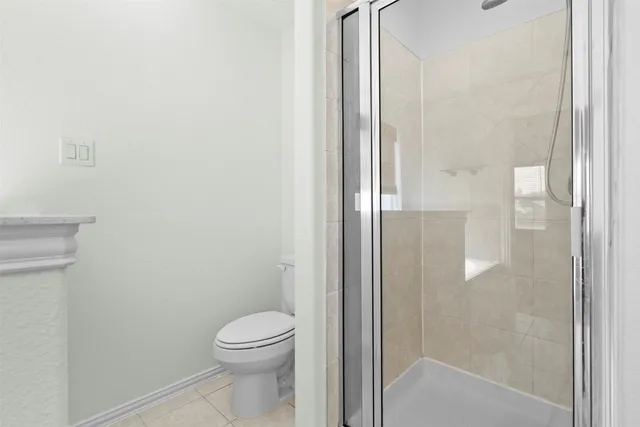 a bathroom with a toilet and a shower