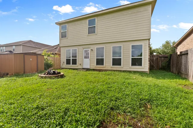 a view of a house with backyard sitting area and garden