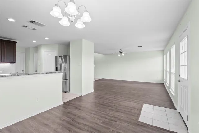 a view of a kitchen with a dishwasher cabinets and wooden floor