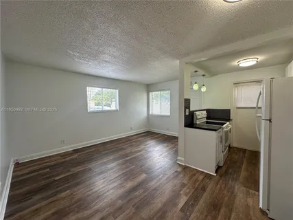 a view of kitchen and hall with wooden floor