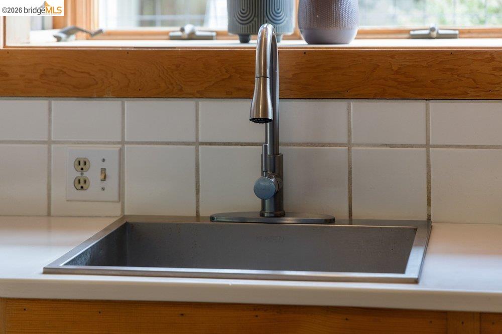 287 Purdue Avenue Kensington, CA 94708 - Photo 24 of 60 Undermount stainless steel sink with a single-handle faucet, set into a light-toned countertop