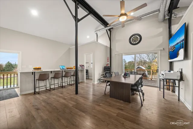 a living room with fireplace furniture and a wooden floor
