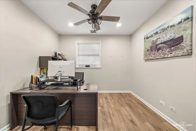 a room with a sink and a chandelier fan