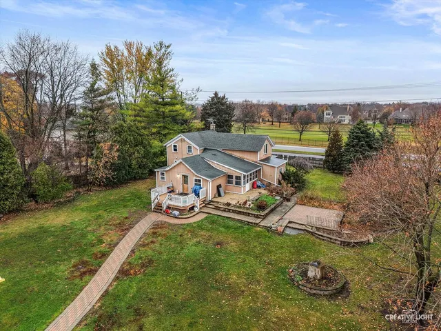 an aerial view of a house with garden space and street view