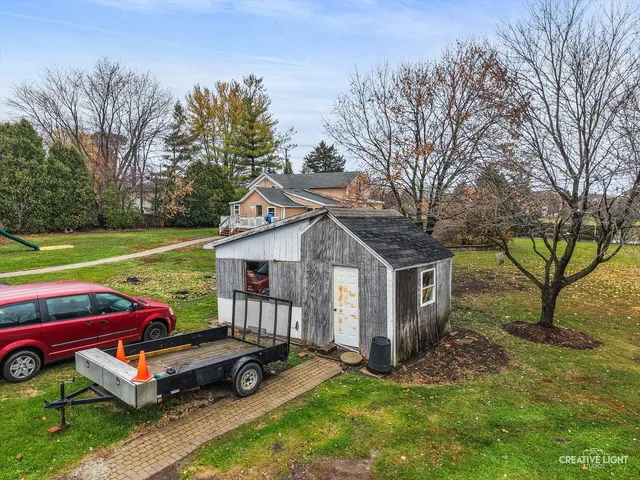 a backyard of a house with table and chairs