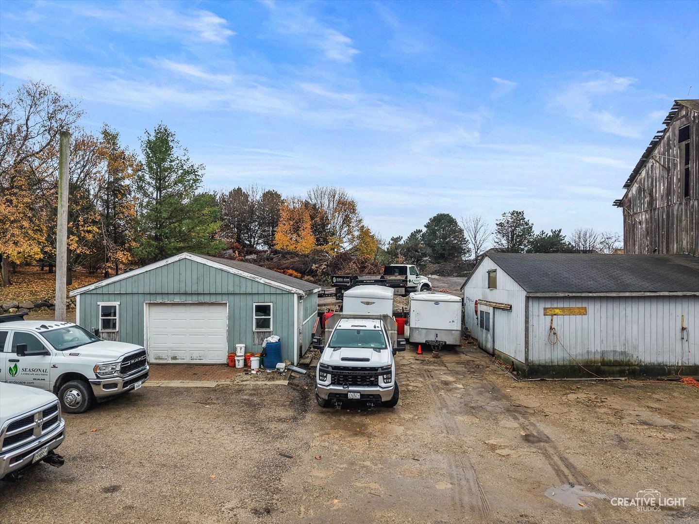 3711 West Algonquin Road Algonquin, IL 60102 - Photo 10 of 21 a view of a white house covered with tall trees