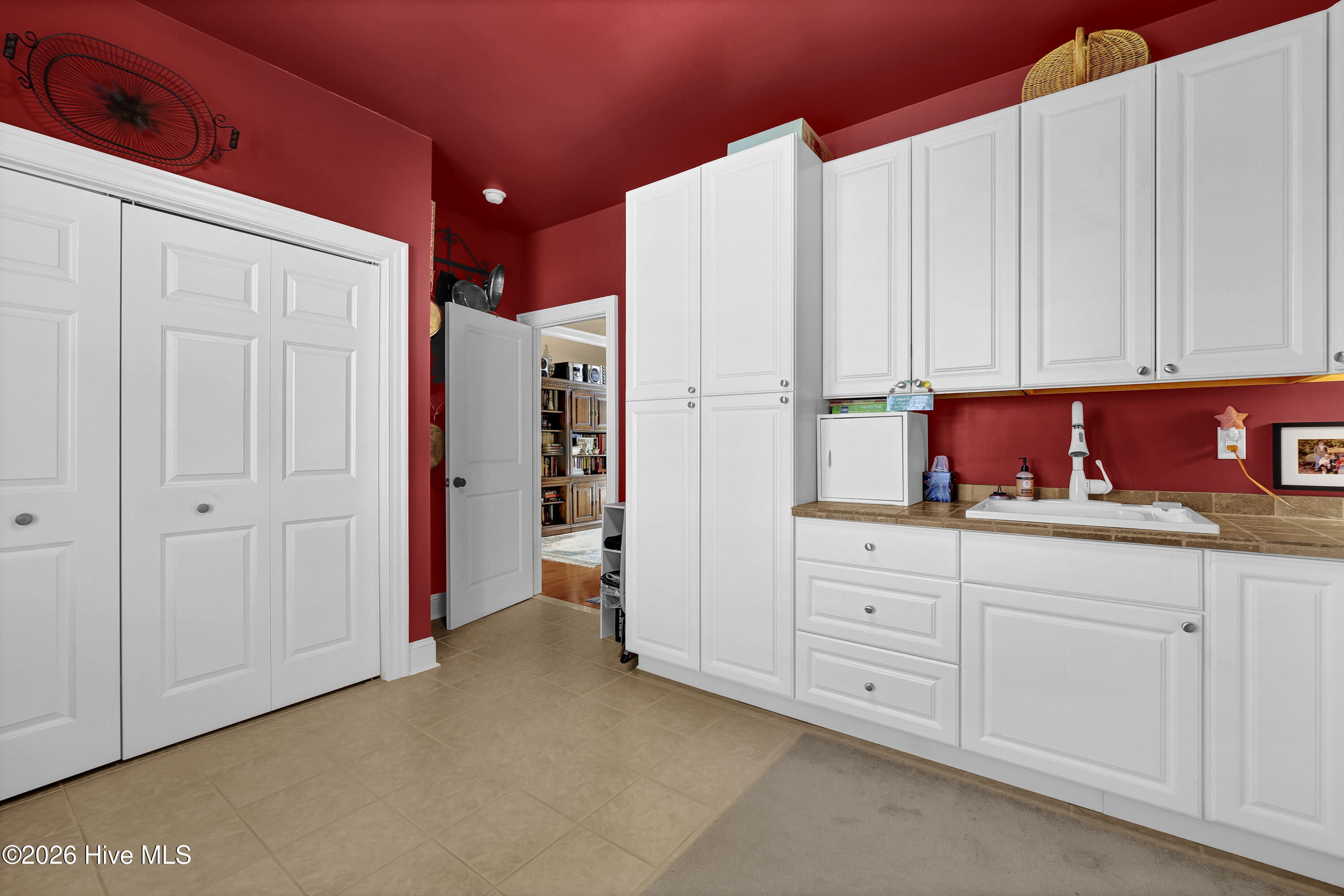 10 W Ridge Surf City, NC 28445 - Photo 26 of 86 laundry room with utility sink, built in cabinets, and closets