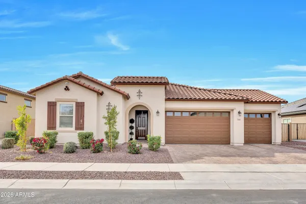 a front view of a house with a yard and garage