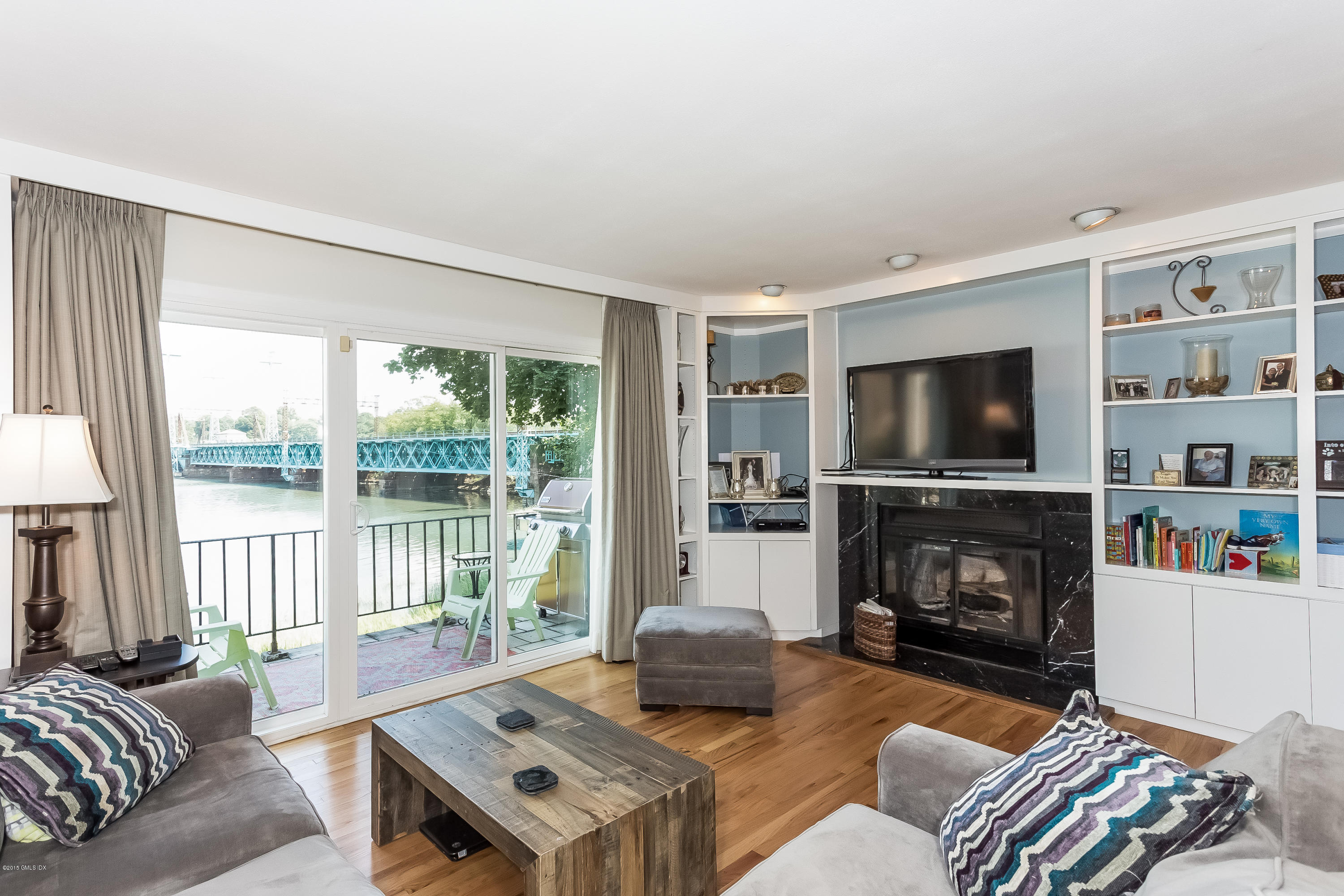 100 Strickland Road, Unit 9 Cos Cob, CT 06807 - Photo 1 of 21 a living room with furniture and a flat screen tv