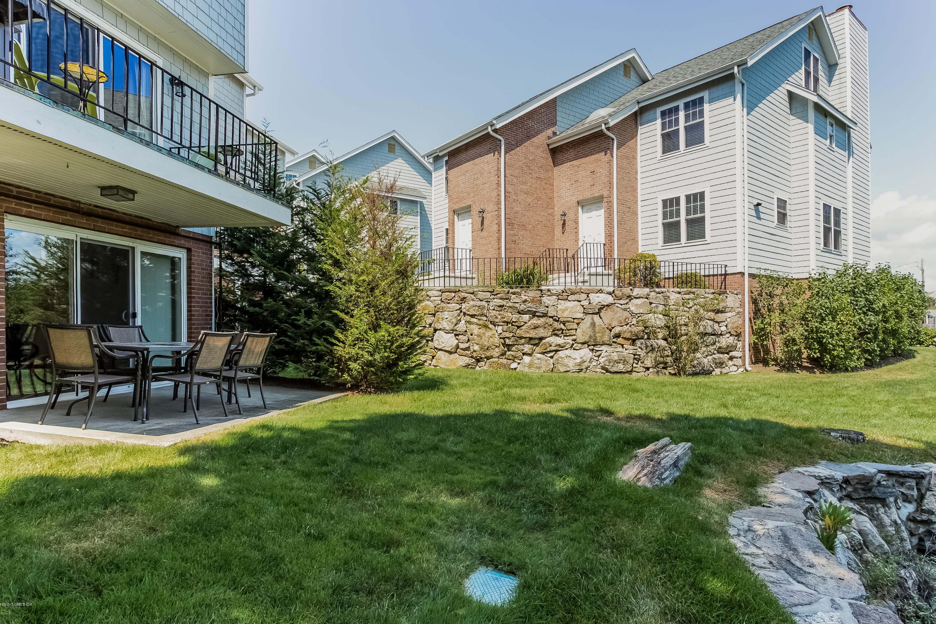 100 Strickland Road, Unit 9 Cos Cob, CT 06807 - Photo 15 of 21 a view of a house with a yard and sitting area