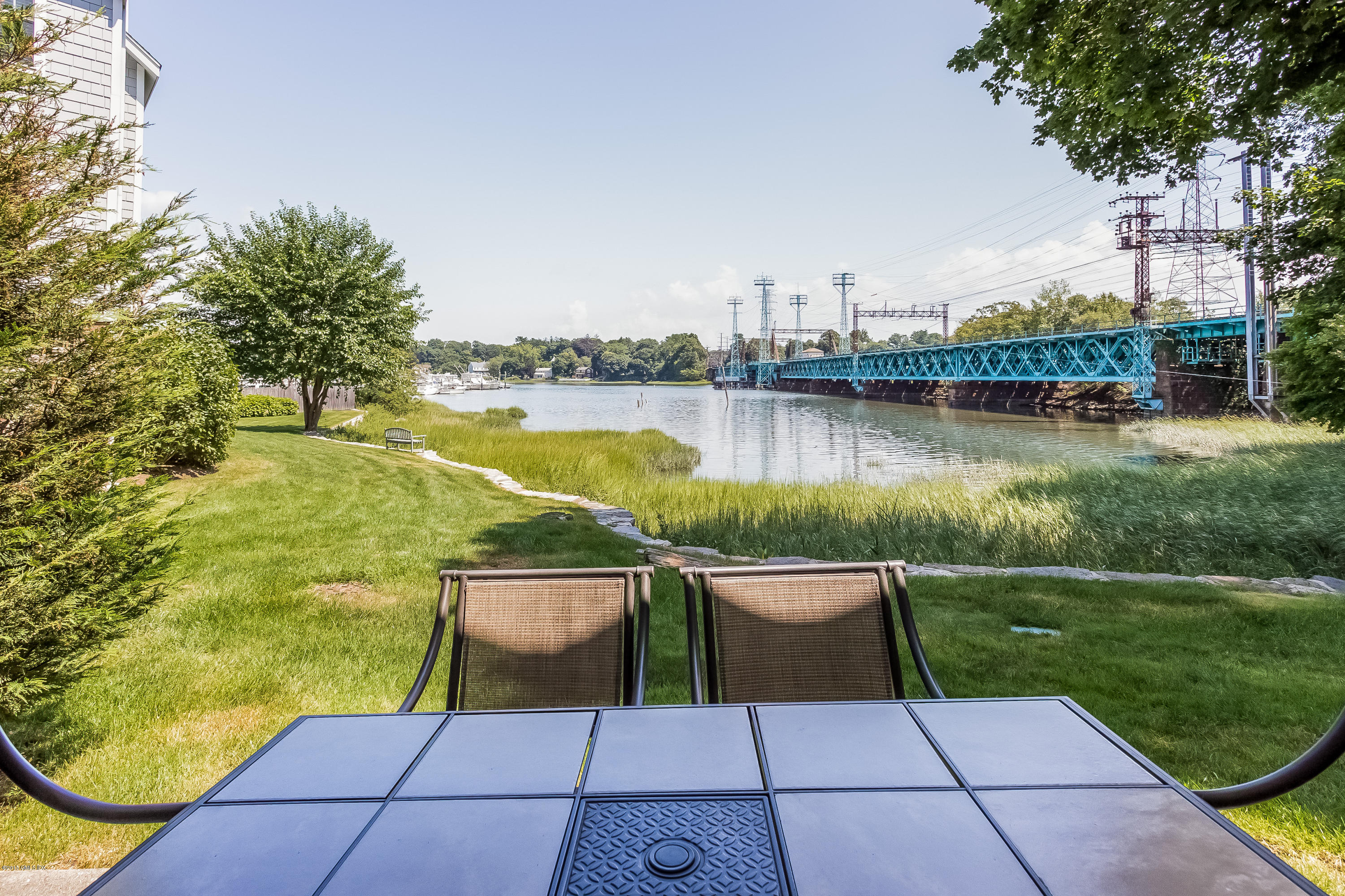 100 Strickland Road, Unit 9 Cos Cob, CT 06807 - Photo 16 of 21 a view of a lake with a garden