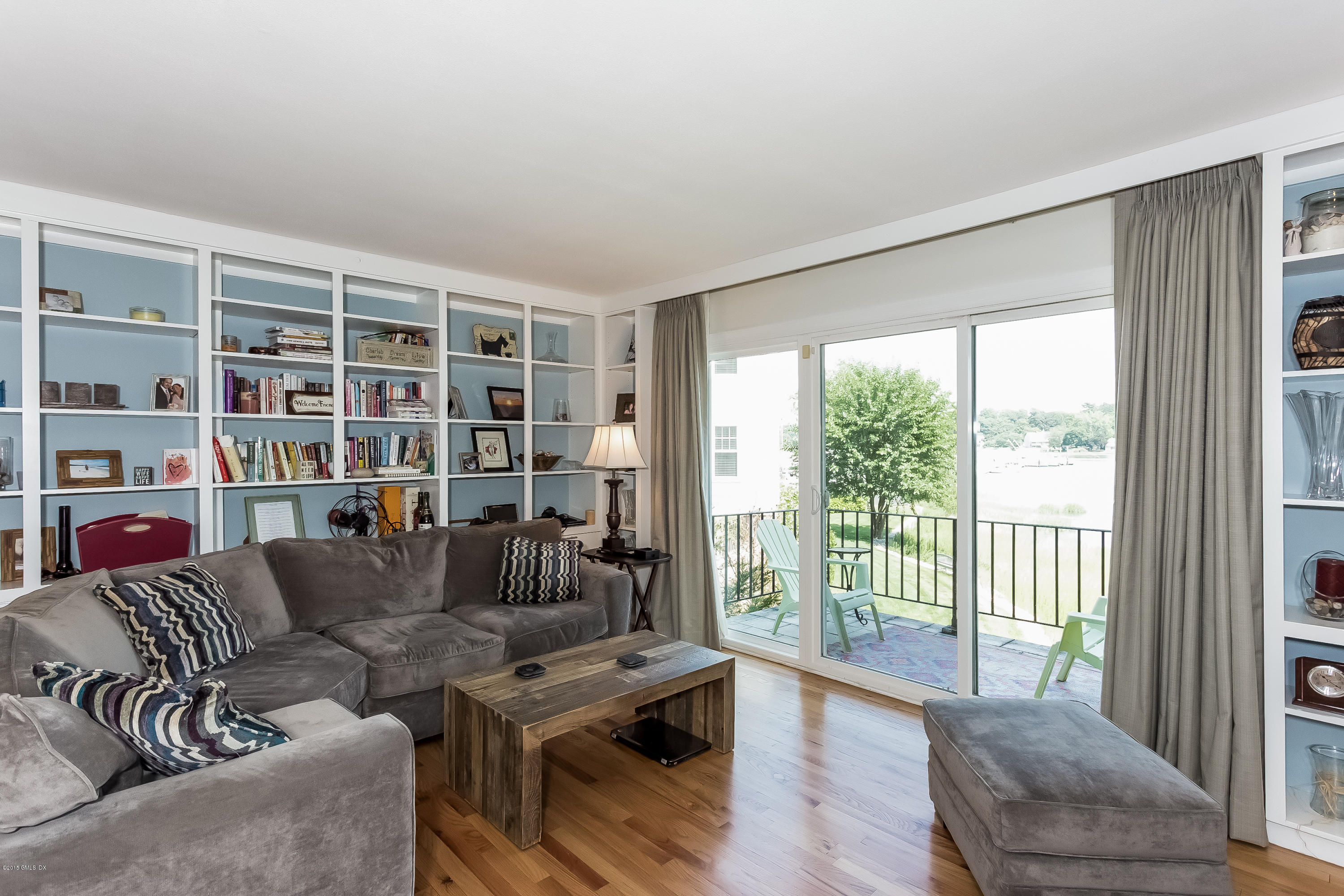 100 Strickland Road, Unit 9 Cos Cob, CT 06807 - Photo 3 of 21 a living room with furniture and a large window