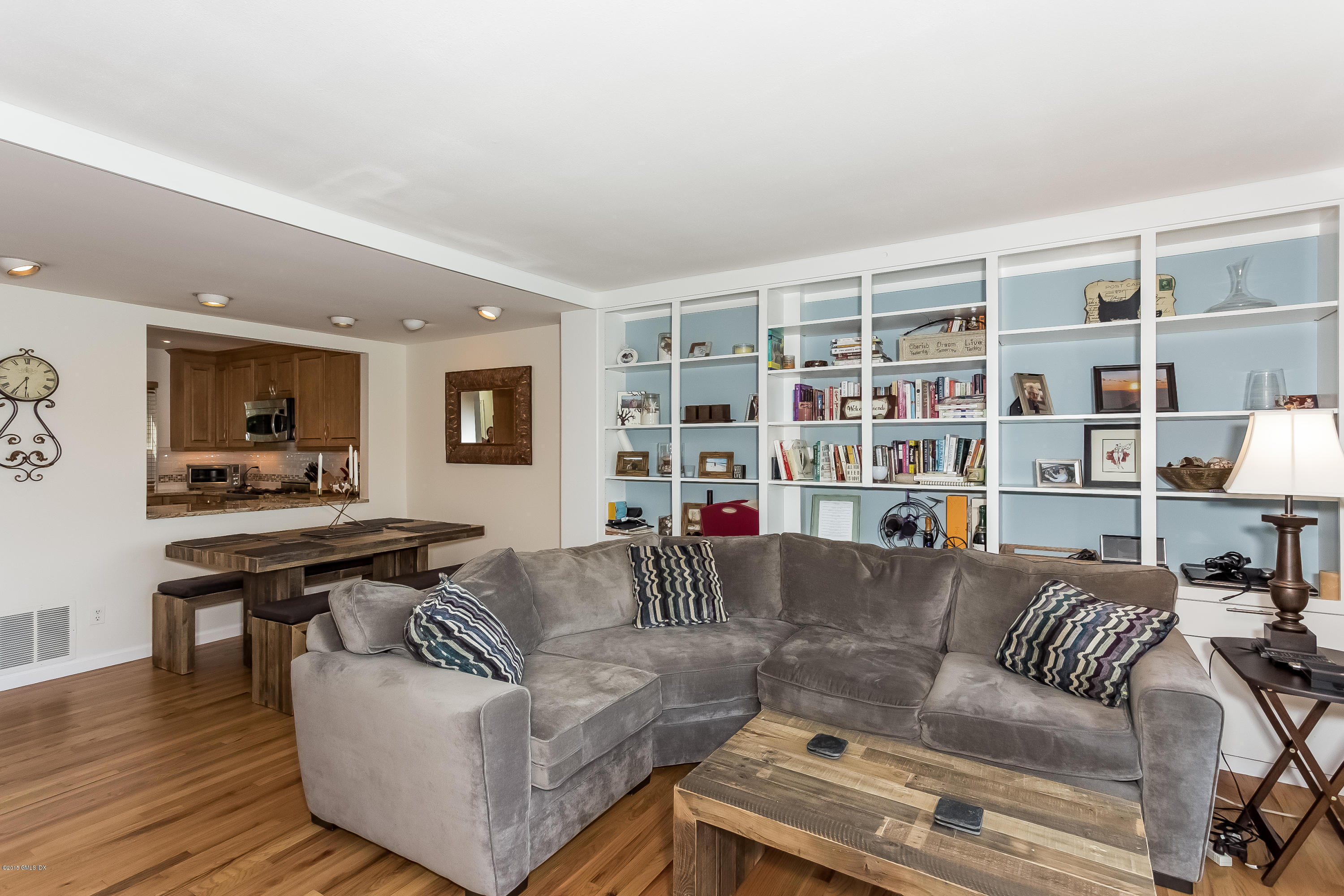 100 Strickland Road, Unit 9 Cos Cob, CT 06807 - Photo 4 of 21 a living room with furniture and a book shelf