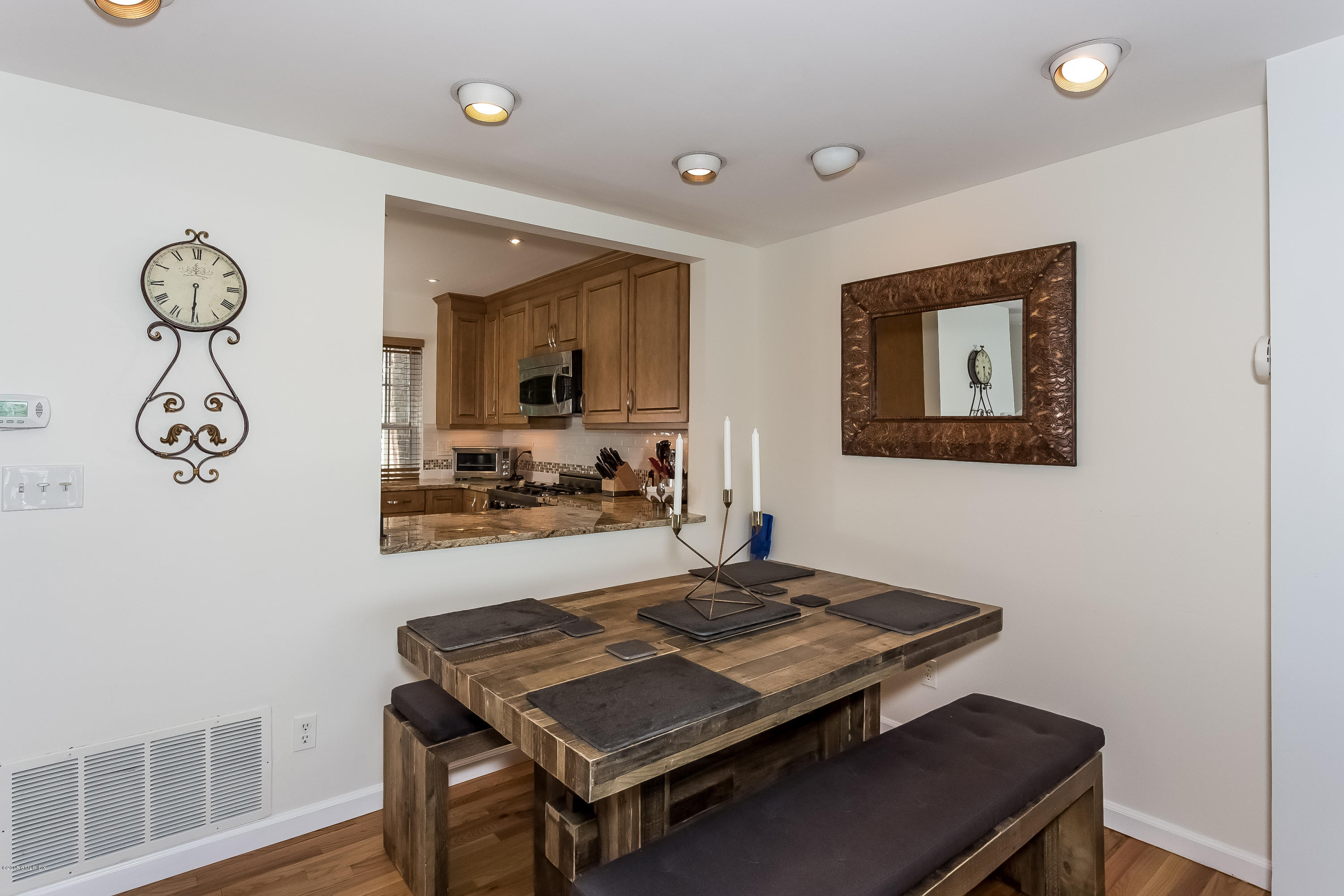100 Strickland Road, Unit 9 Cos Cob, CT 06807 - Photo 5 of 21 a living room with a table and a chair