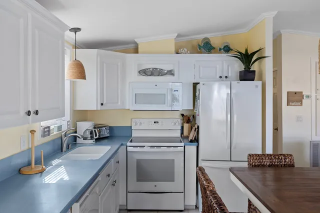 a kitchen with white cabinets and a sink