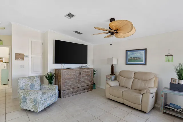 a living room with furniture a window and a chandelier