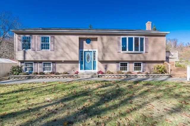 a view of a house with pool and a yard