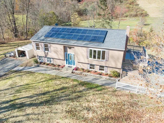 a view of a house with pool and sitting area