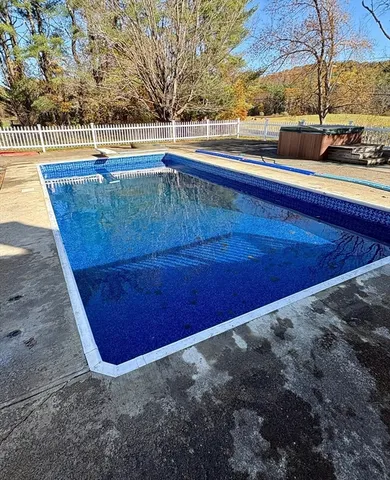 a large kitchen with granite countertop a stove top oven a sink dishwasher a dining table and chairs with wooden floor