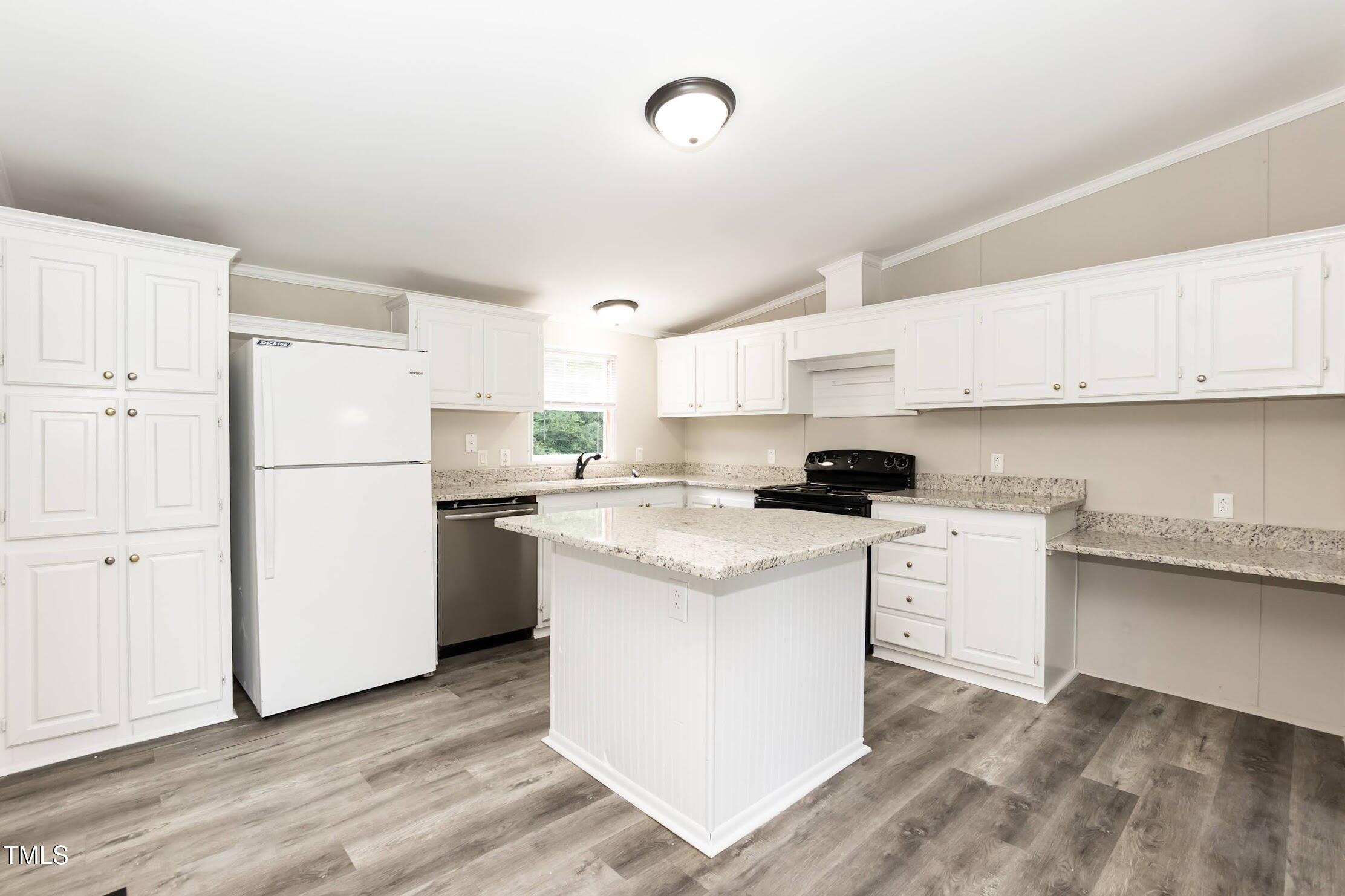 40 Beaver Run Road Spring Hope, NC 27882 - Photo 13 of 28 a kitchen with white cabinets and white appliances