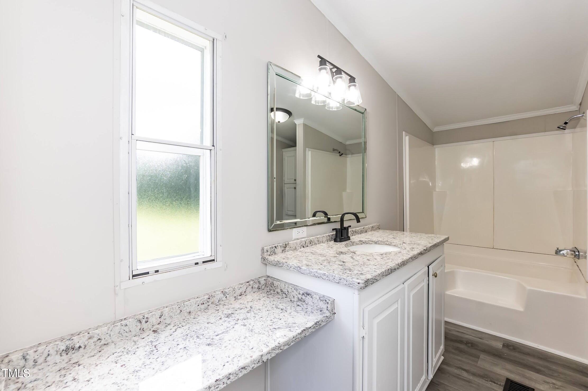 40 Beaver Run Road Spring Hope, NC 27882 - Photo 24 of 28 a bathroom with a granite countertop sink and a mirror
