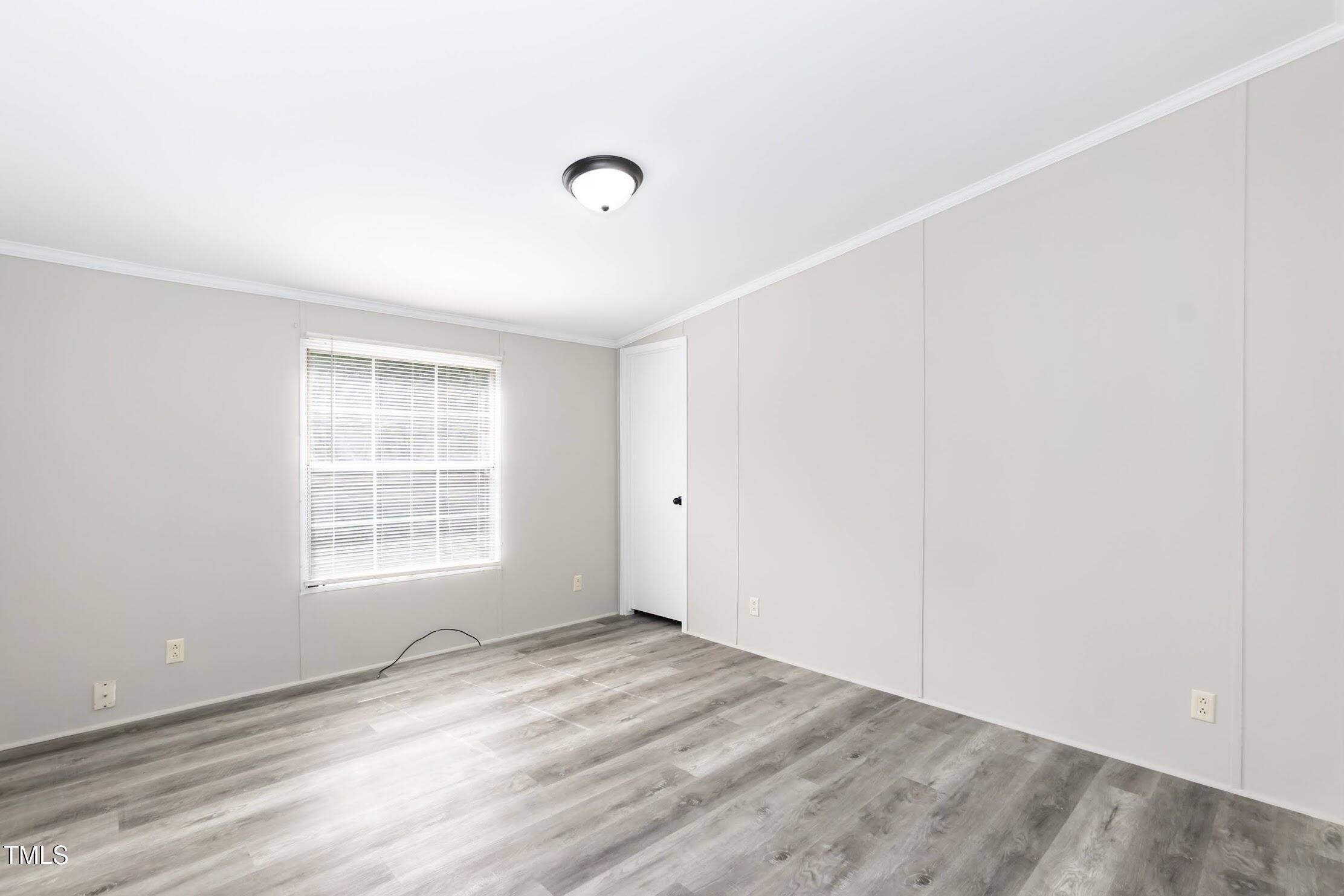 40 Beaver Run Road Spring Hope, NC 27882 - Photo 26 of 28 an empty room with wooden floor and windows