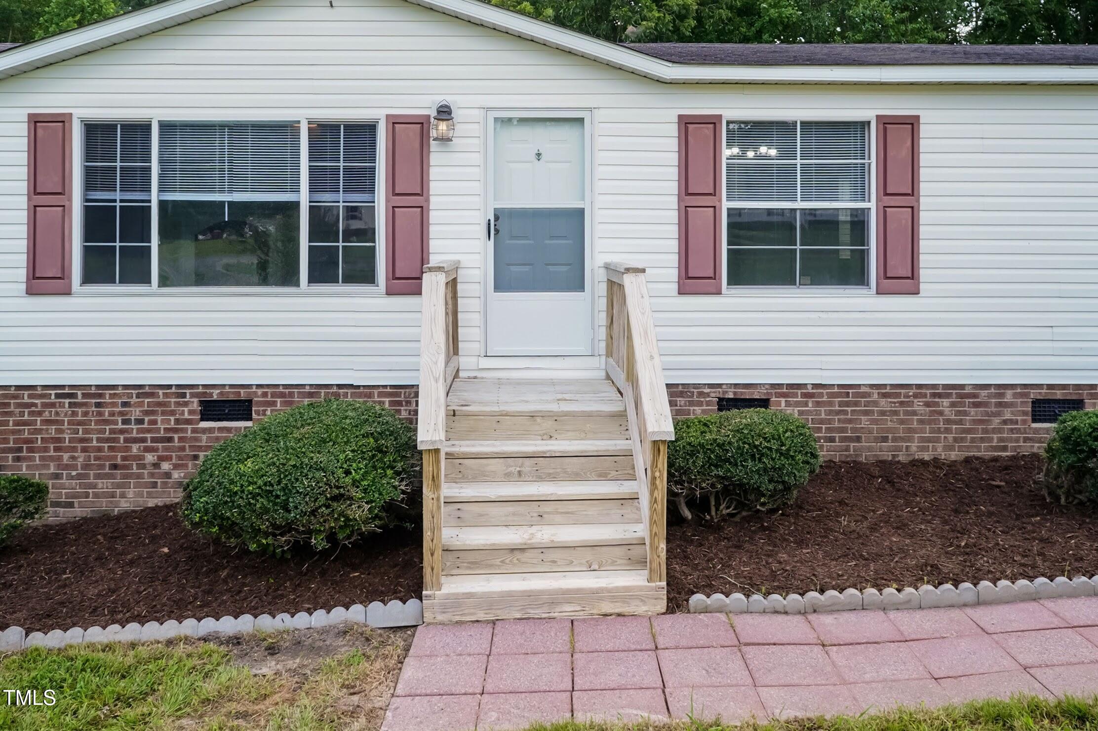 40 Beaver Run Road Spring Hope, NC 27882 - Photo 5 of 28 a front view of a house with a yard and potted plants
