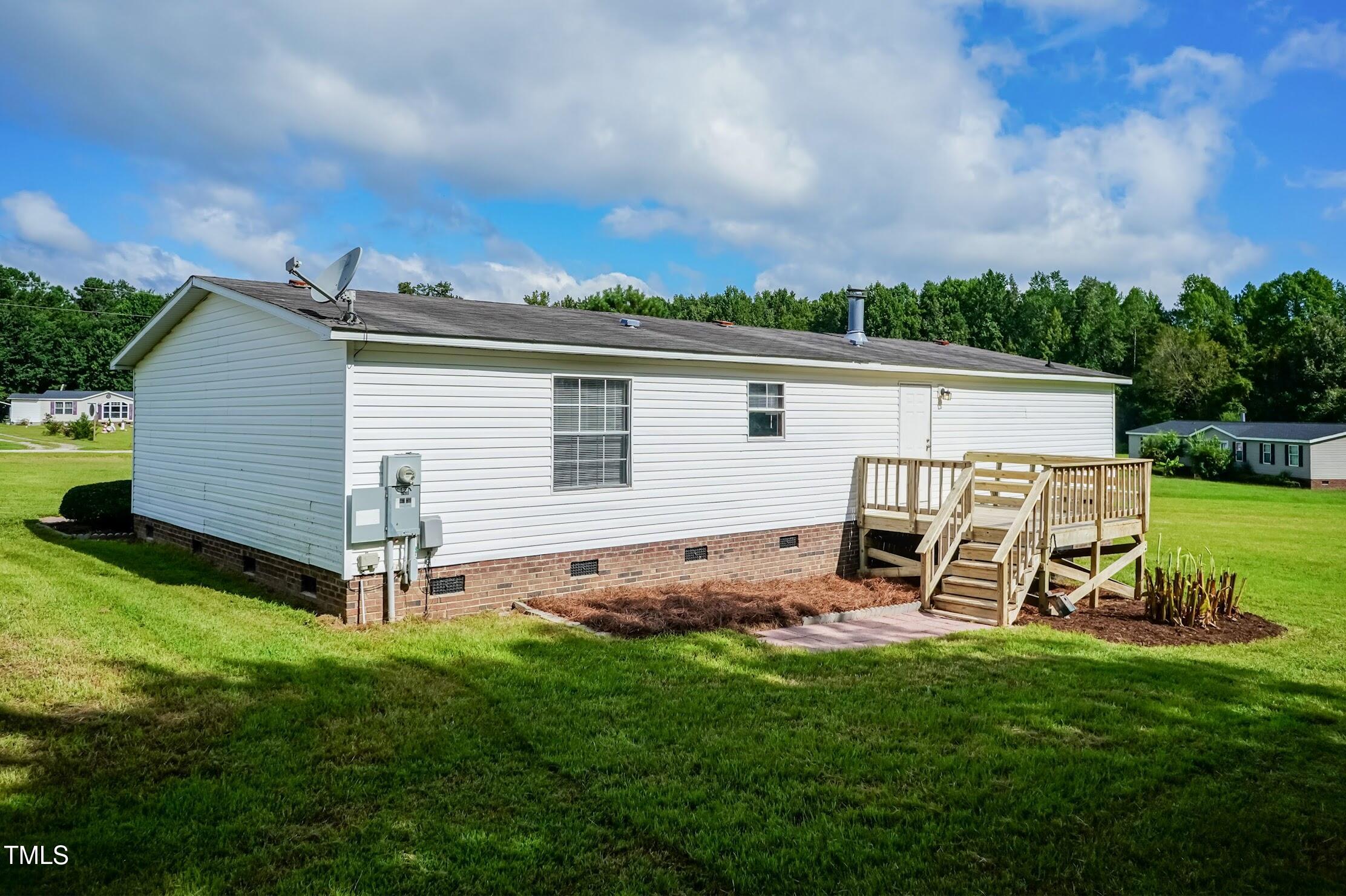 40 Beaver Run Road Spring Hope, NC 27882 - Photo 6 of 28 a view of a backyard with table and chairs a barbeque grill and a small yard