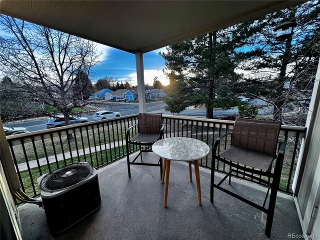 a view of a roof deck with furniture