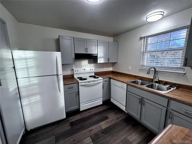 a kitchen with white cabinets sink and white appliances