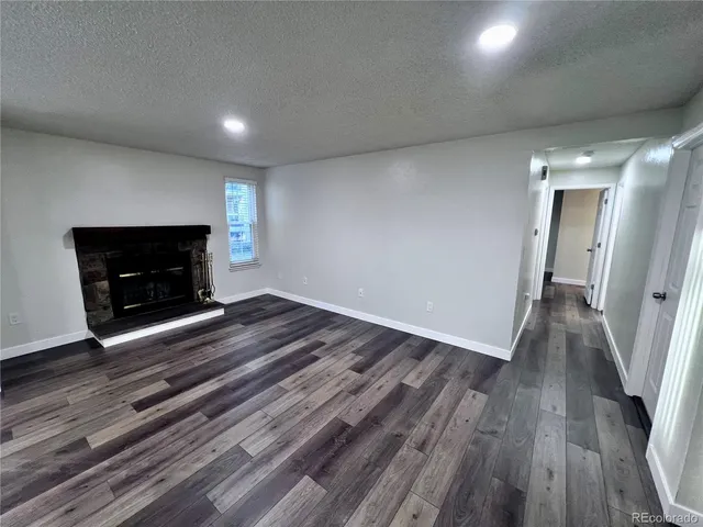 wooden floor in an empty room with a fireplace