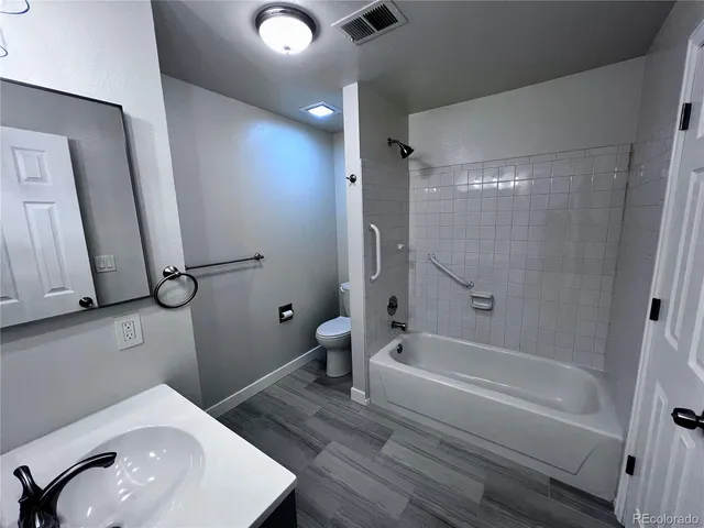 a bathroom with a sink a toilet and a bathtub