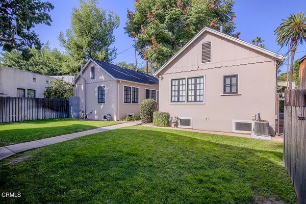a view of a house with a yard and a garden