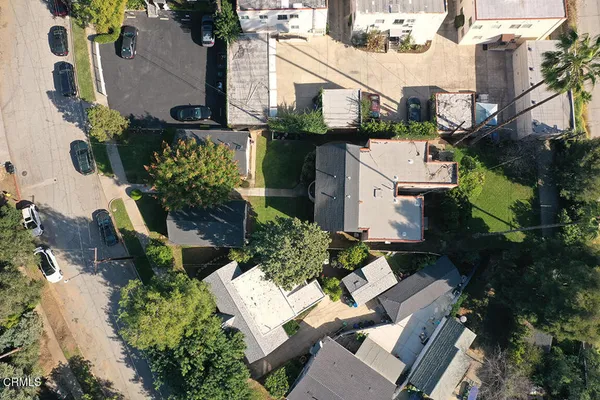 an aerial view of a house with a yard and garden