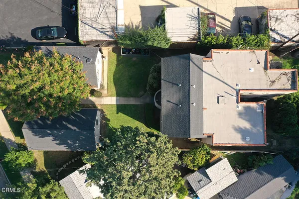 a view of a pathway of house with potted plants