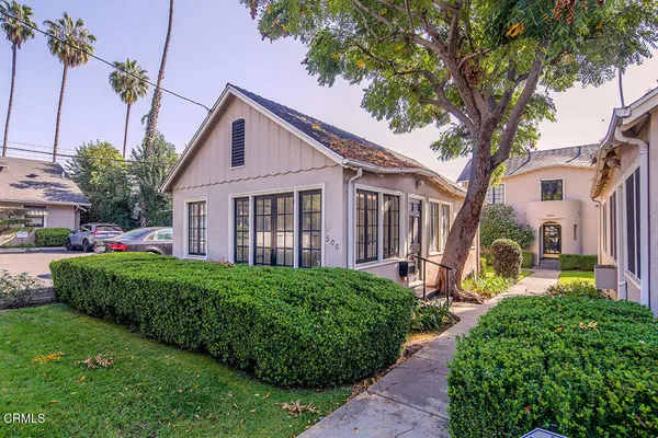 a view of a house with a small yard and plants