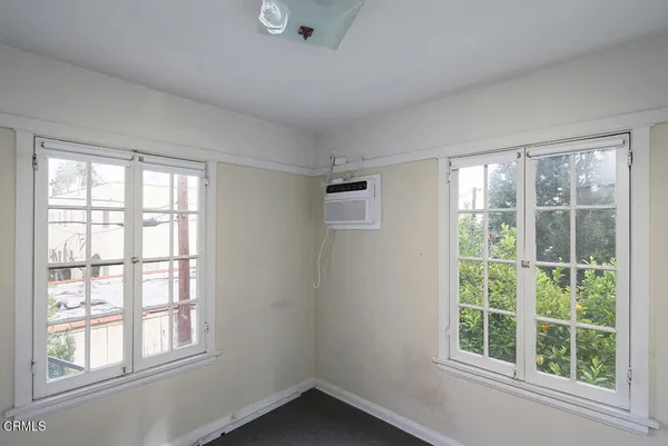 a view of a hallway with wooden floor and closet area
