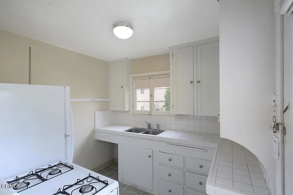 a kitchen with a sink and cabinets