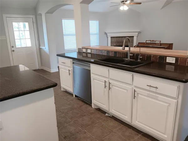 a kitchen with a sink and chandelier