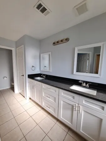a kitchen with granite countertop white cabinets and white appliances