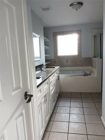 a kitchen with a sink a counter top space and a window