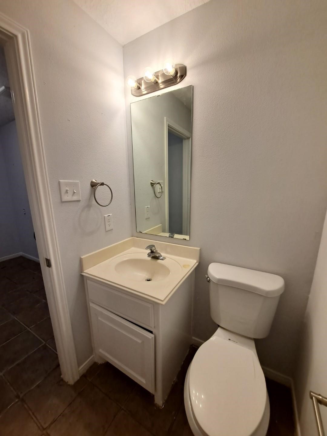 7411 Augusta Lane Rosharon, TX 77583 - Photo 25 of 38 a bathroom with a toilet sink and mirror