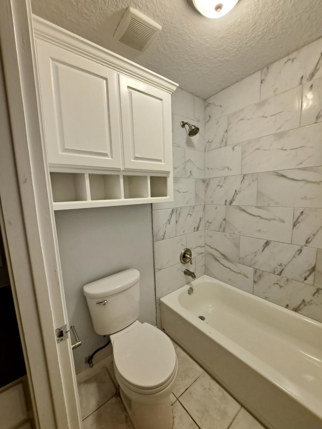 7411 Augusta Lane Rosharon, TX 77583 - Photo 29 of 38 a bathroom with a toilet and a bathtub