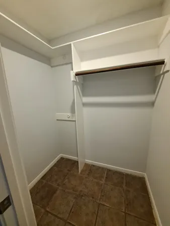 a white toilet sitting next to a white sink and vanity
